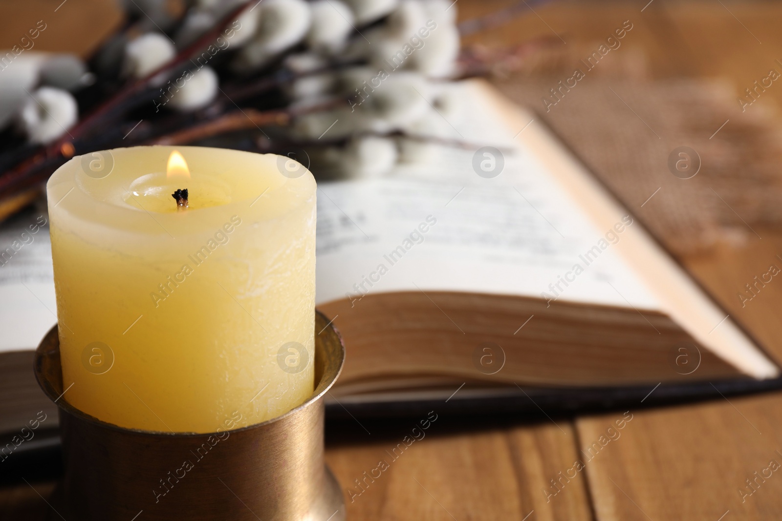 Photo of Burning candle on table, closeup. Space for text