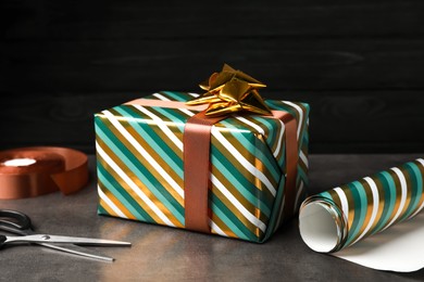 Photo of Beautifully wrapped gift box on grey table
