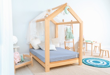 View of cozy child's room interior with cute bed