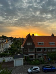 Picturesque view of city street with beautiful buildings at sunrise