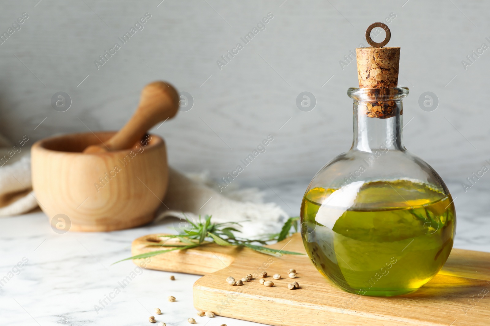 Photo of Composition with hemp oil on marble table