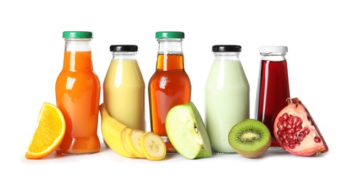 Bottles with different drinks and ingredients on white background