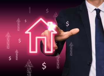 Mortgage rate. Man touching illustration of house on virtual screen against dark background, closeup