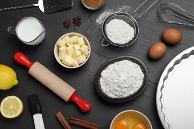 Cooking utensils and ingredients on black table, flat lay