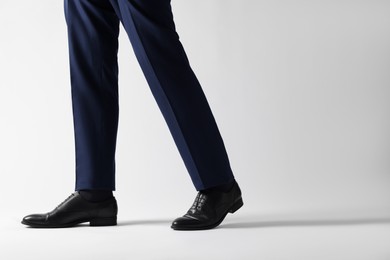 Businessman in leather shoes on white background, closeup