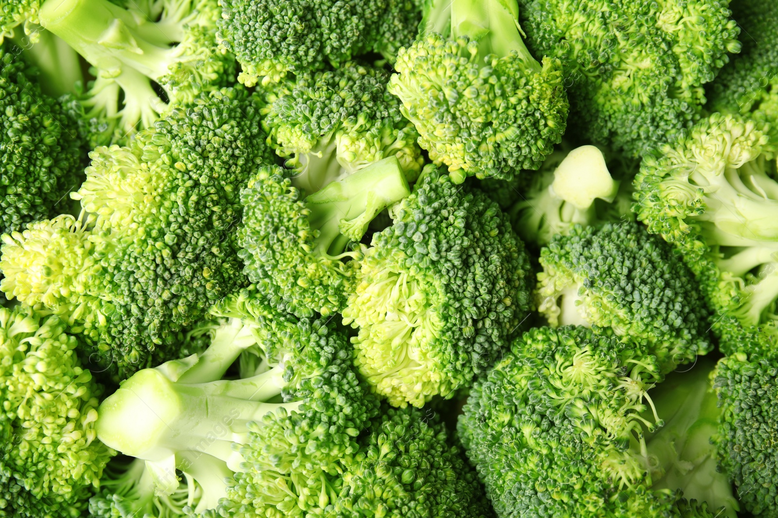 Photo of Fresh green broccoli as background, top view. Organic food