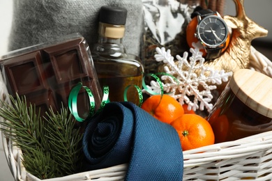 Photo of Christmas gift set in wicker basket, closeup