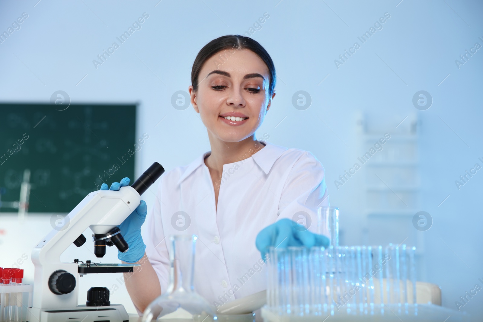 Photo of Female scientist working with sample in modern chemistry laboratory