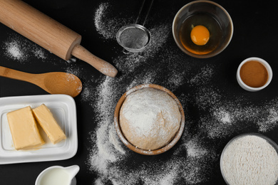 Flat lay composition with ingredients for baking pie on black table