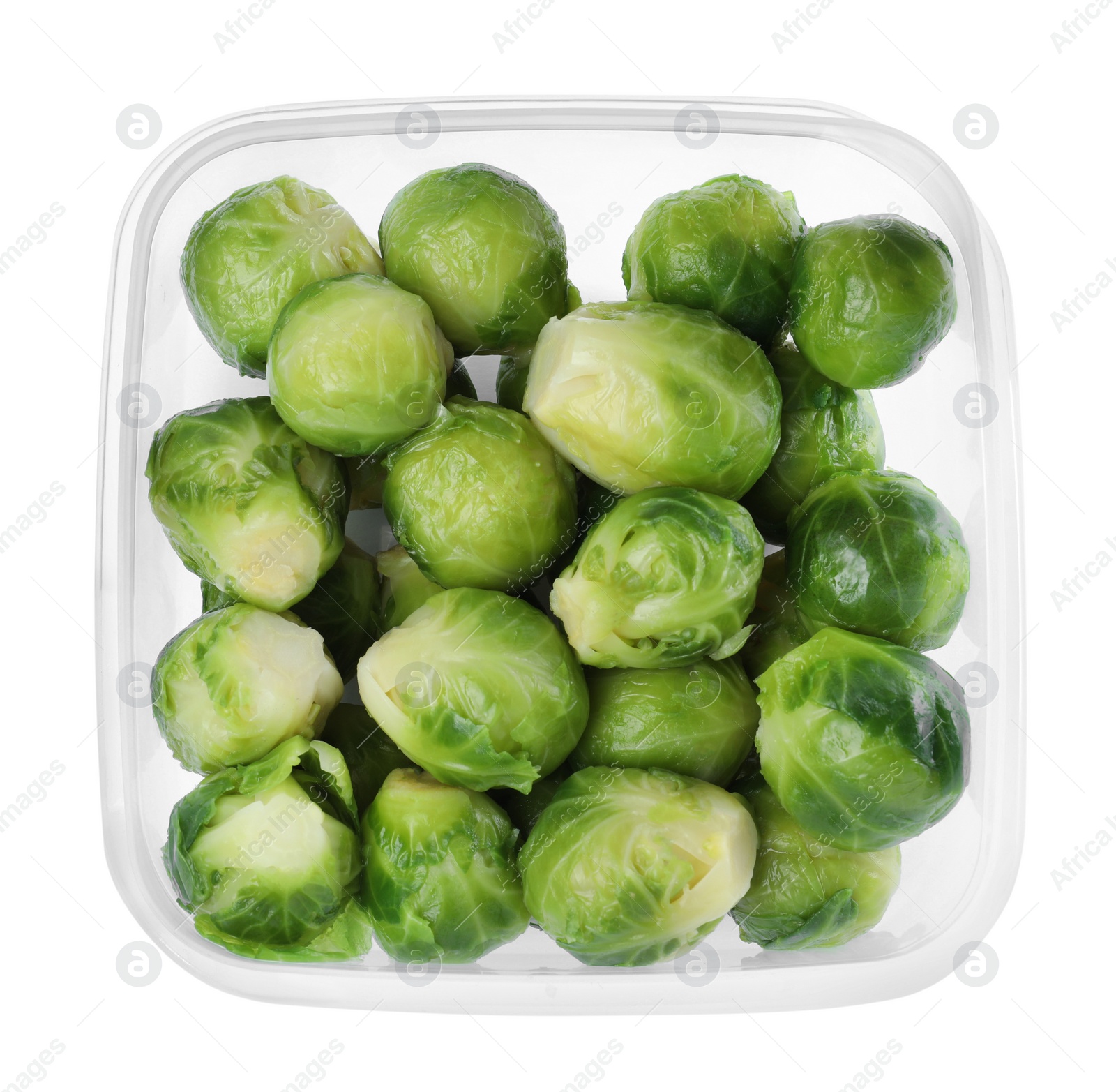 Photo of Brussels sprouts in plastic container isolated on white, top view