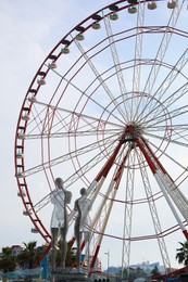 Photo of BATUMI, GEORGIA - MAY 31, 2022: Movable sculptural composition Ali and Nino near Ferris wheel