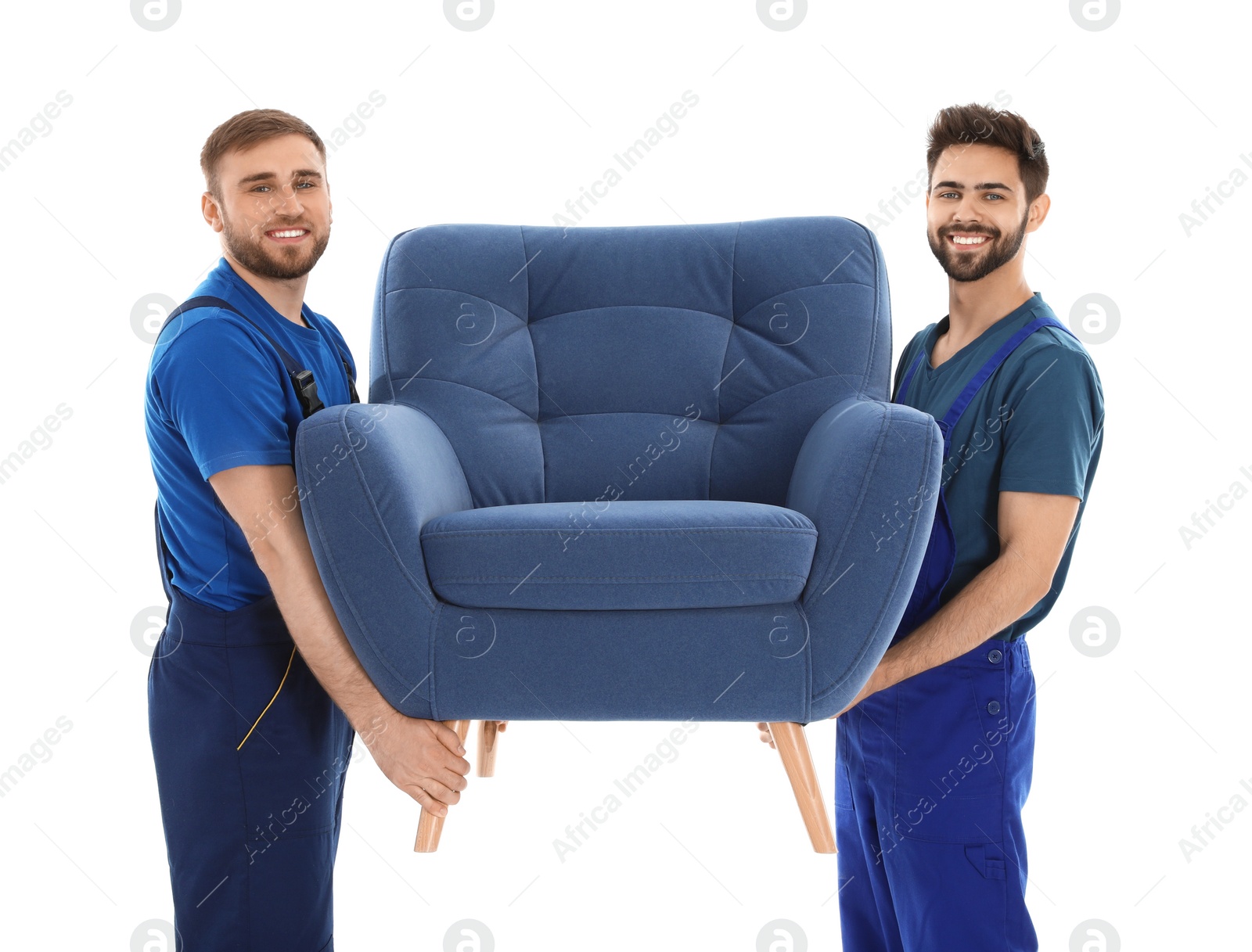 Photo of Young workers carrying armchair isolated on white. Moving service