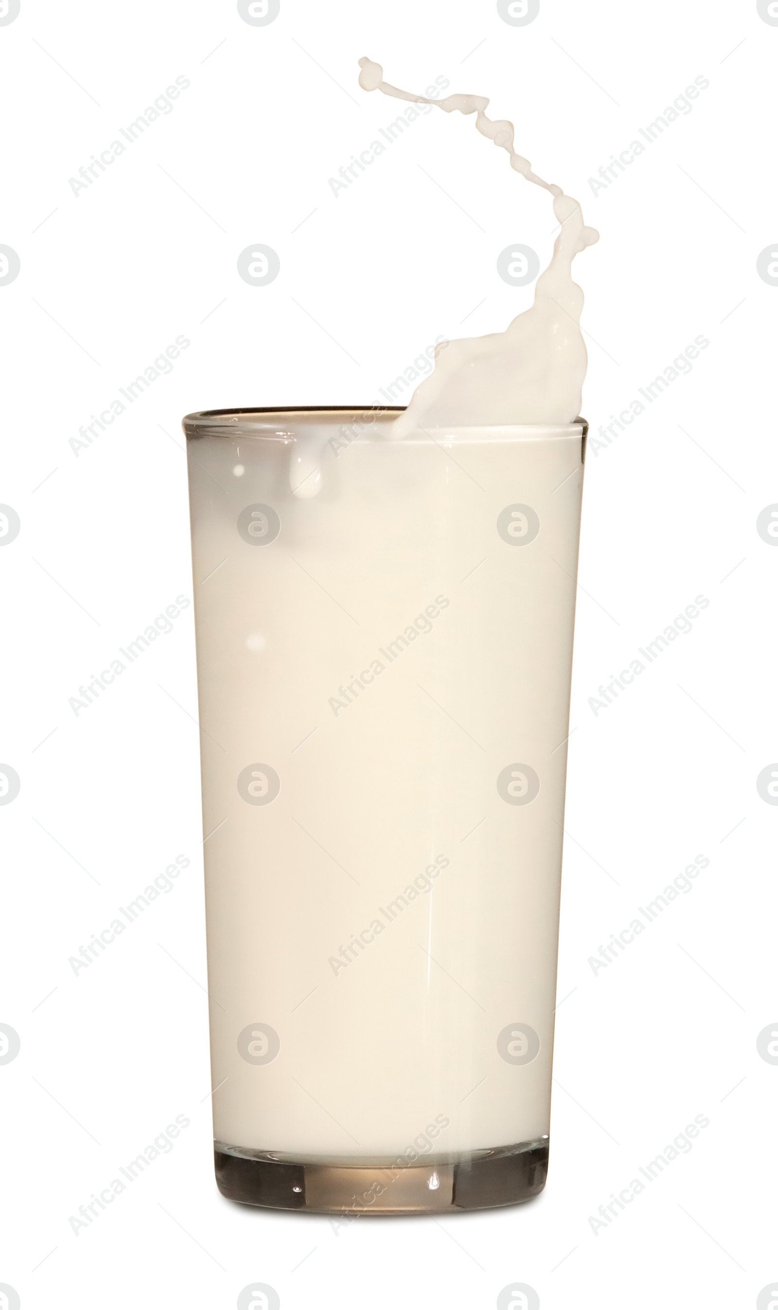 Photo of Milk splashing out of glass on white background
