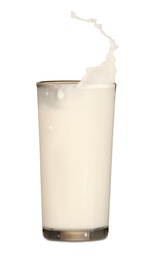 Milk splashing out of glass on white background