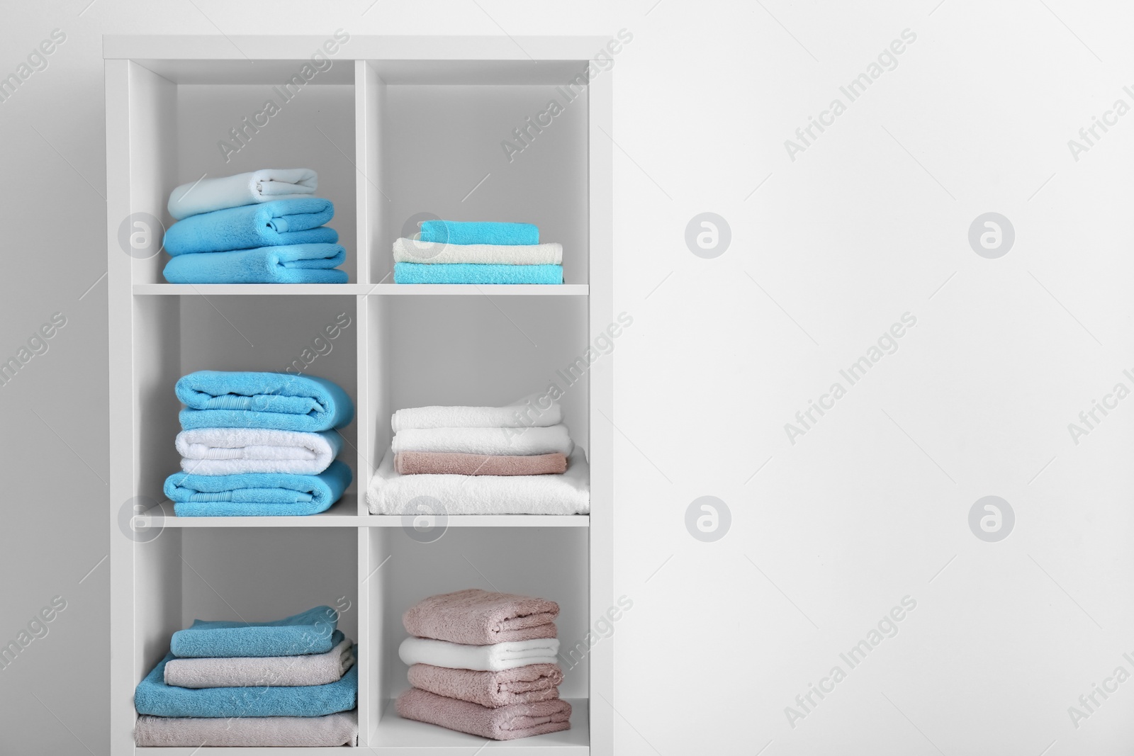 Photo of Clean towels on shelves in bathroom