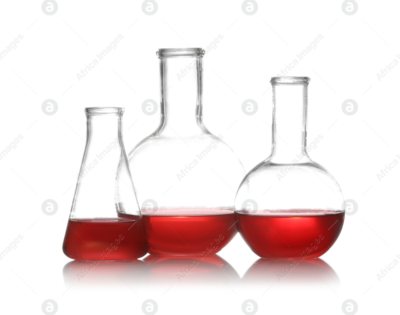 Photo of Group of chemistry glassware with liquid samples isolated on white