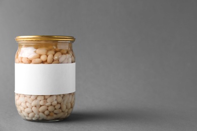 Photo of Jar of pickled beans with blank label on grey background, space for text