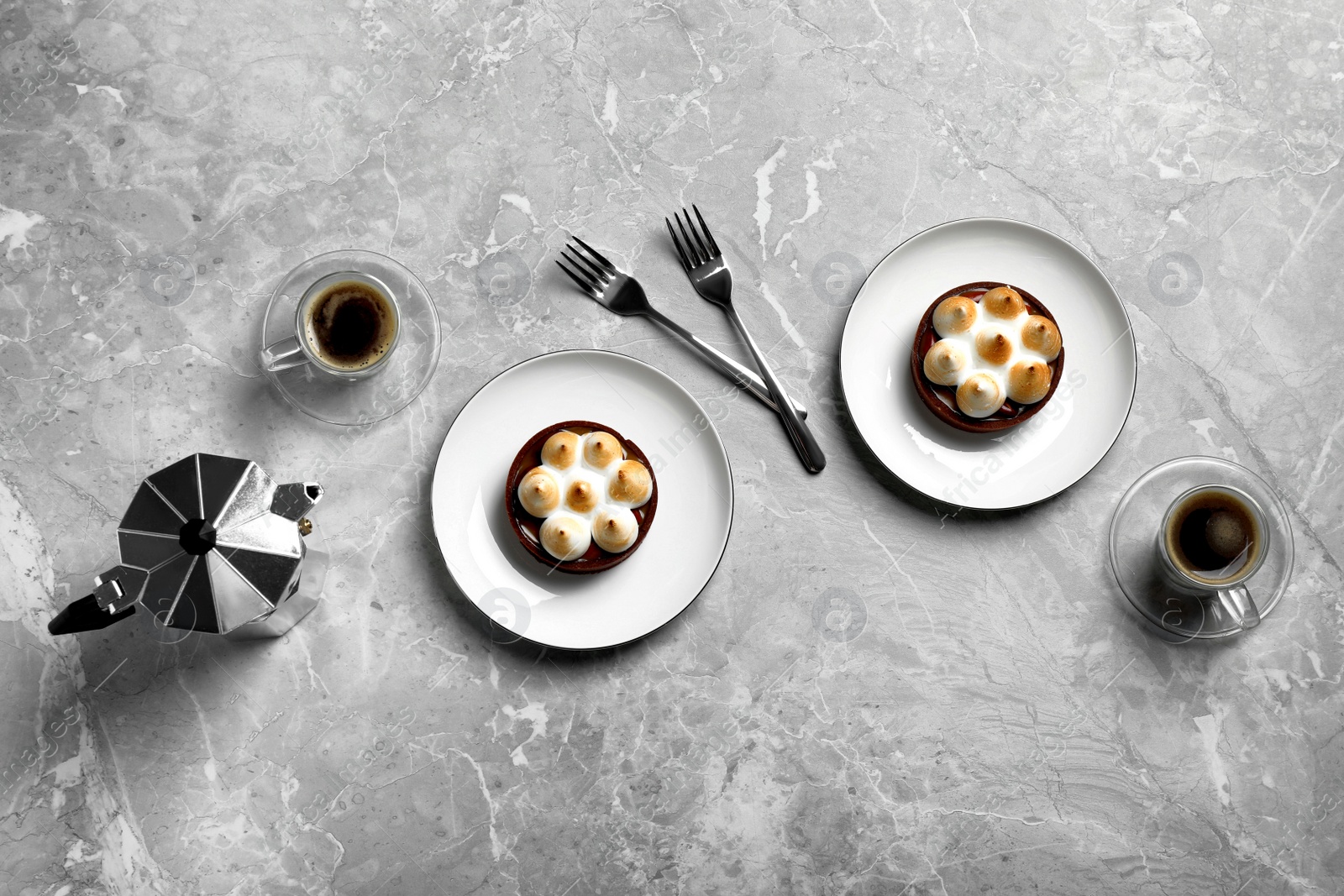 Photo of Delicious salted caramel chocolate tarts with meringue and coffee on light grey marble table, flat lay