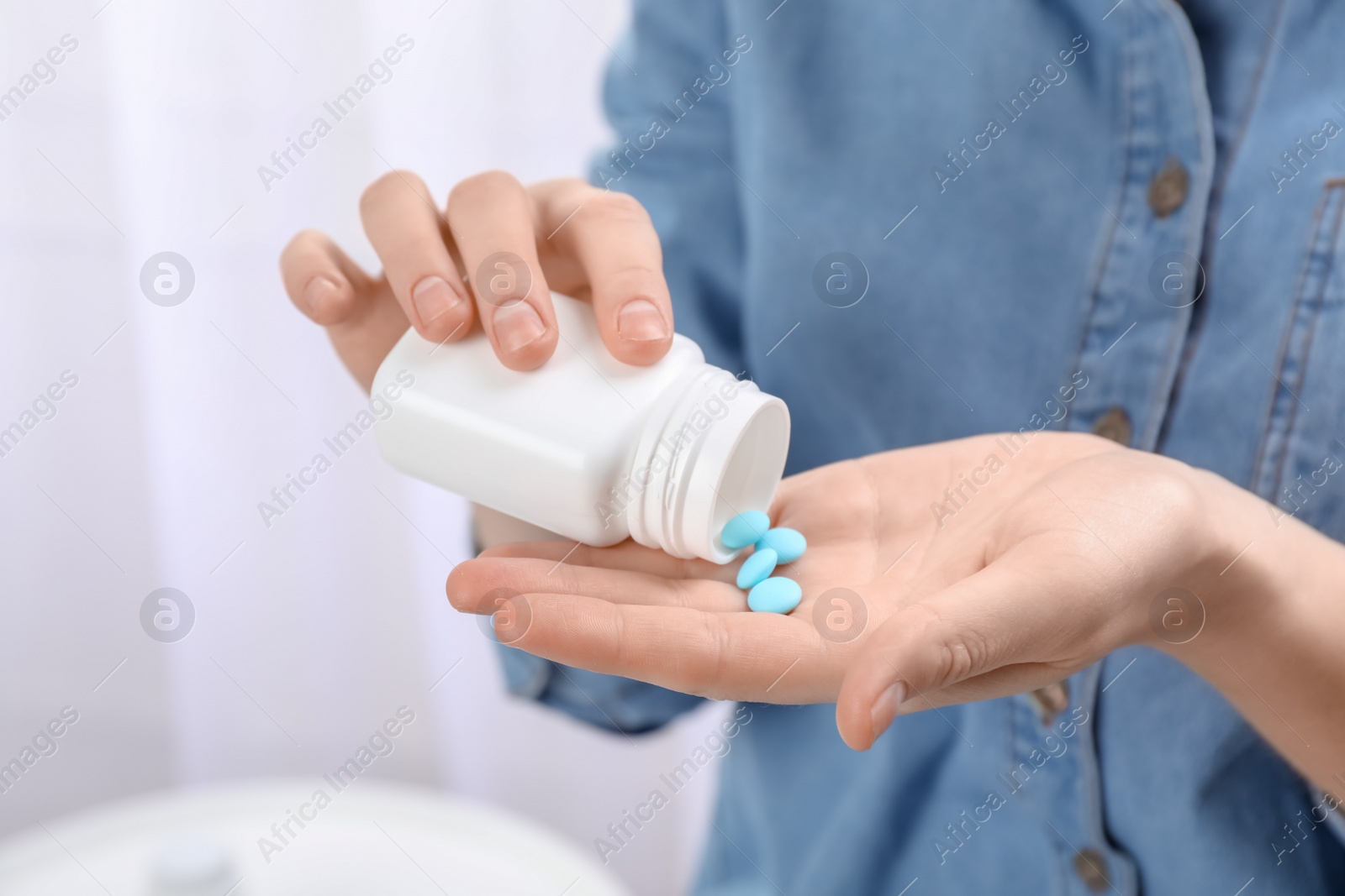 Photo of Young woman with bottle of pills, closeup