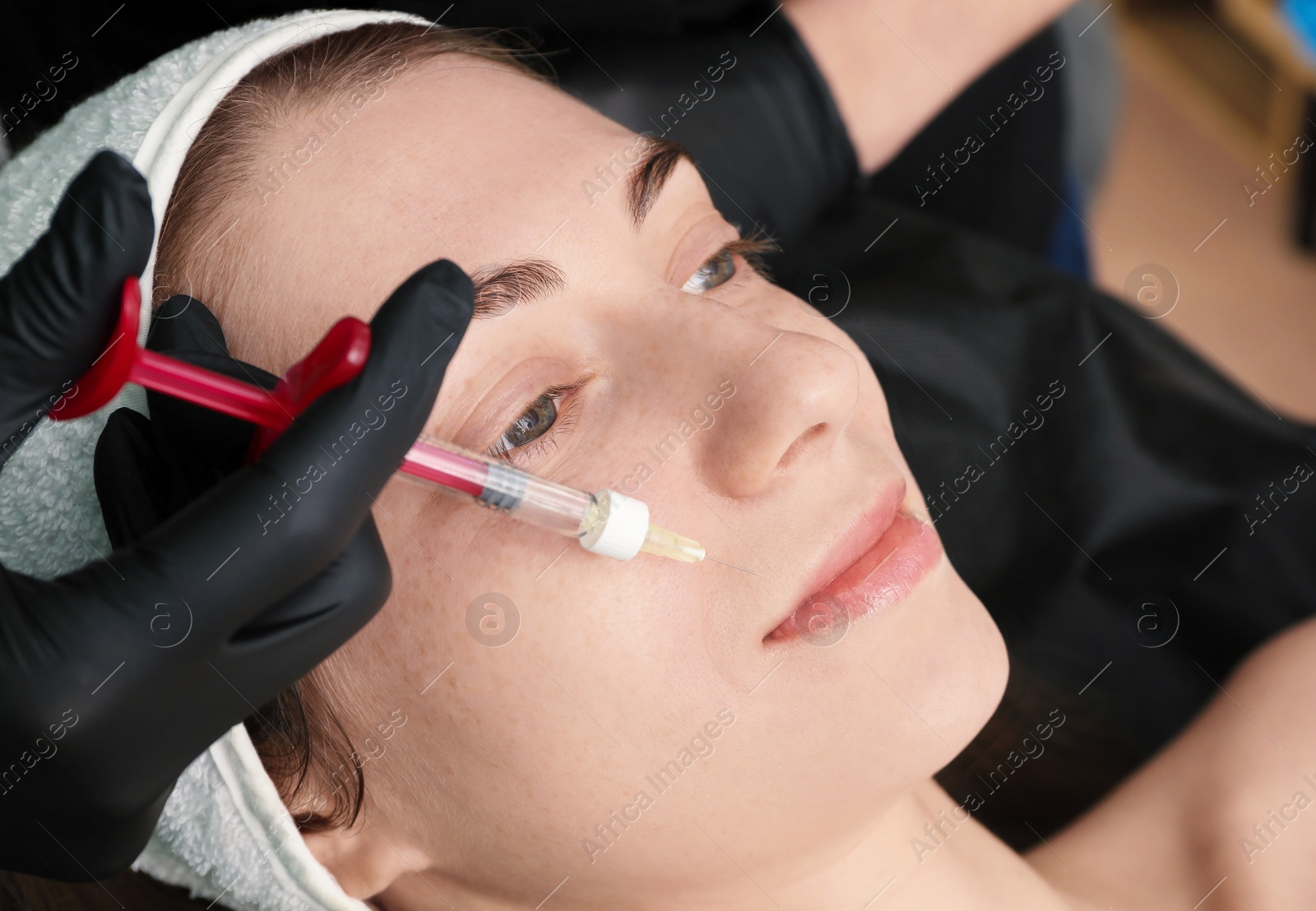 Photo of Cosmetologist giving facial injection to patient, closeup. Cosmetic surgery