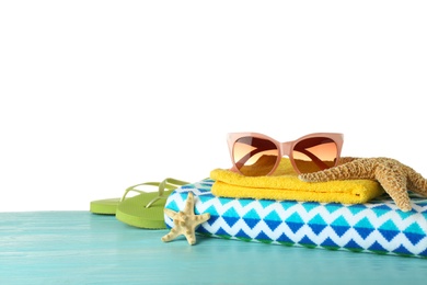 Set of beach accessories on table against white background. Space for text