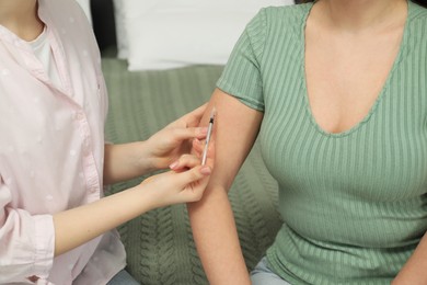 Photo of Diabetes. Woman getting insulin injection indoors, closeup