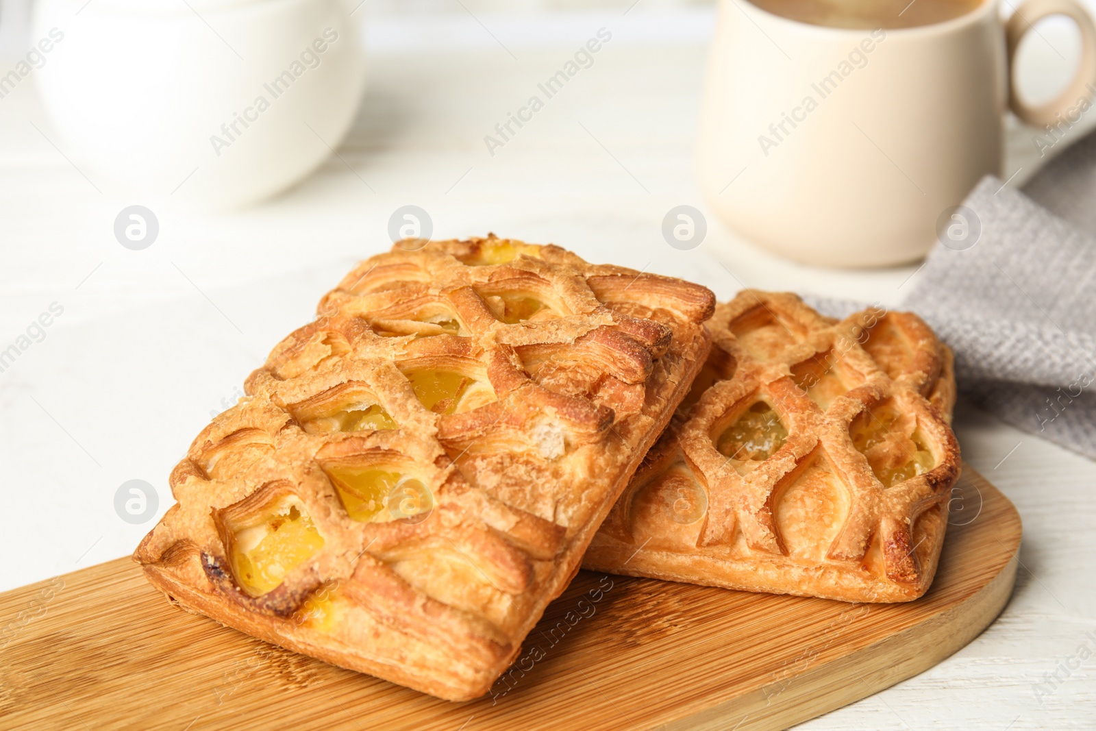 Photo of Fresh tasty pastries on white wooden table, closeup