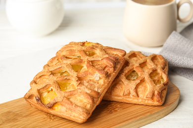 Fresh tasty pastries on white wooden table, closeup