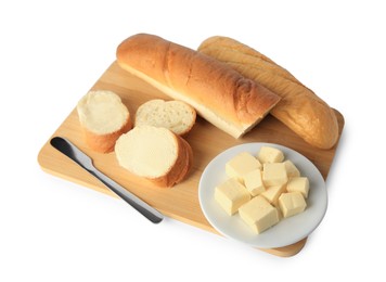 Photo of Whole and cut baguettes with fresh butter on white background