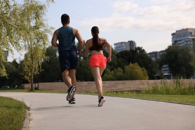 Photo of Healthy lifestyle. Couple running outdoors, low angle view