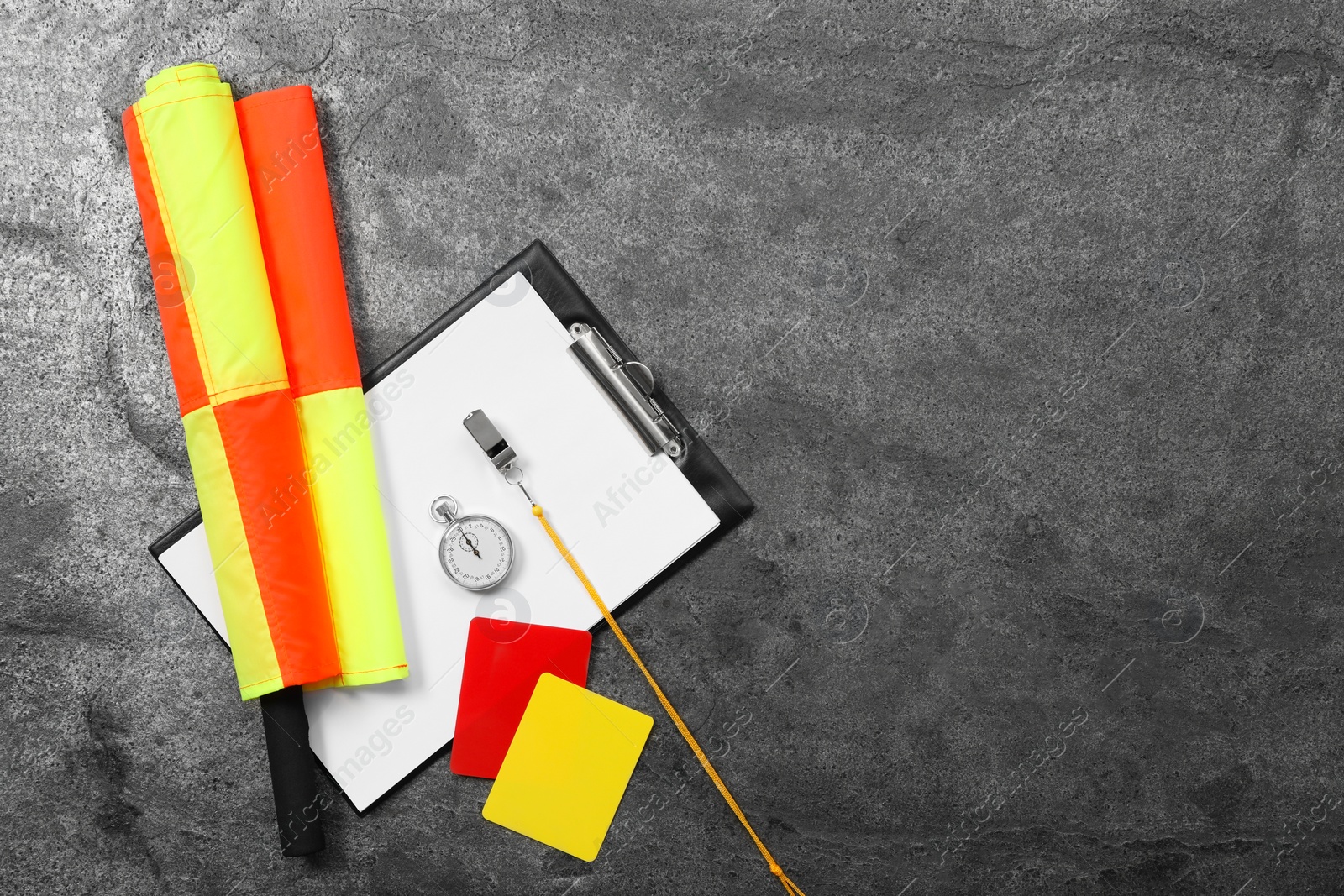 Photo of Different referee equipment on grey table, top view. Space for text