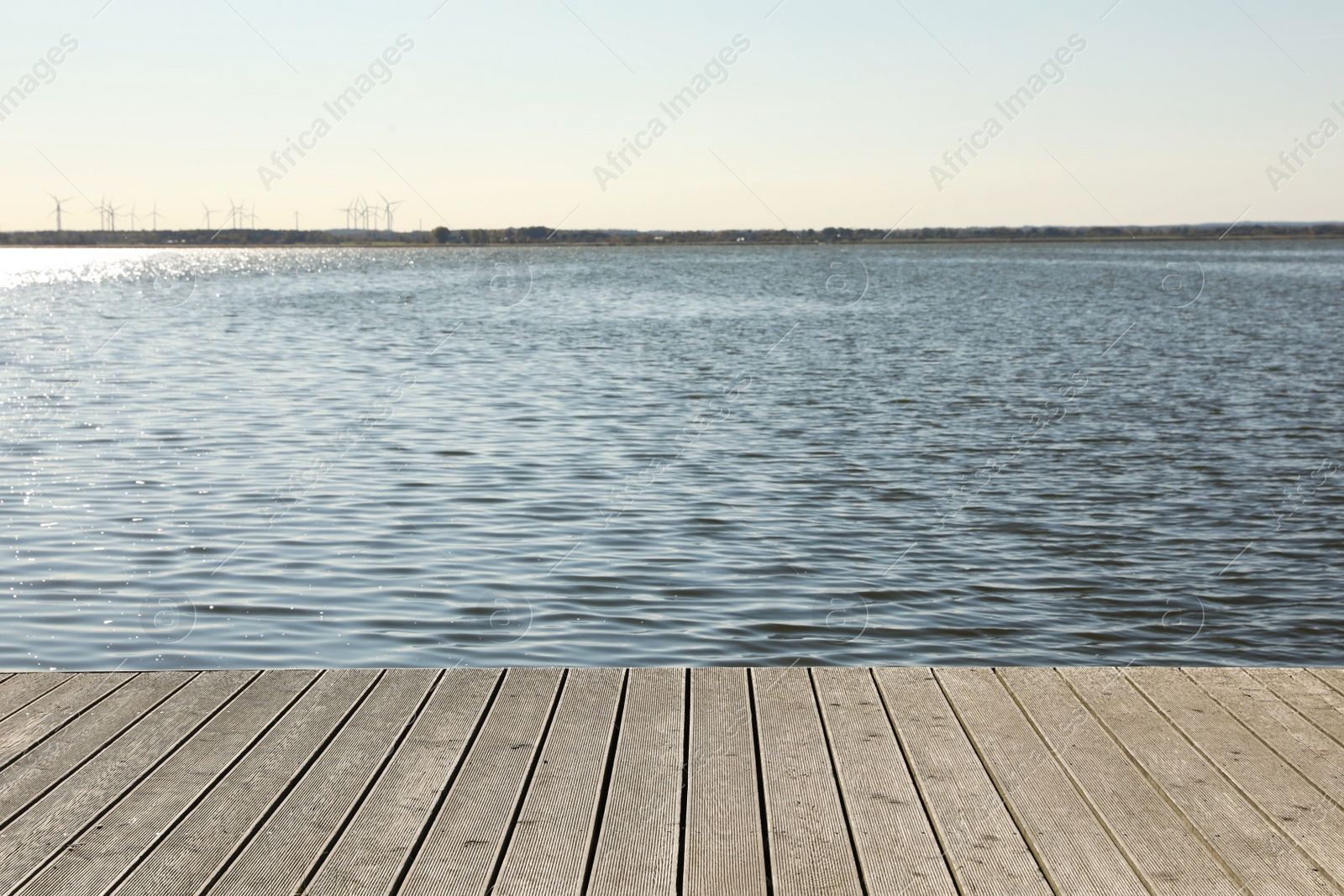 Photo of Beautiful view of wooden terrace near river on sunny day