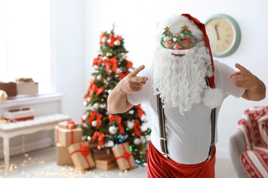 Authentic Santa Claus with funny glasses indoors