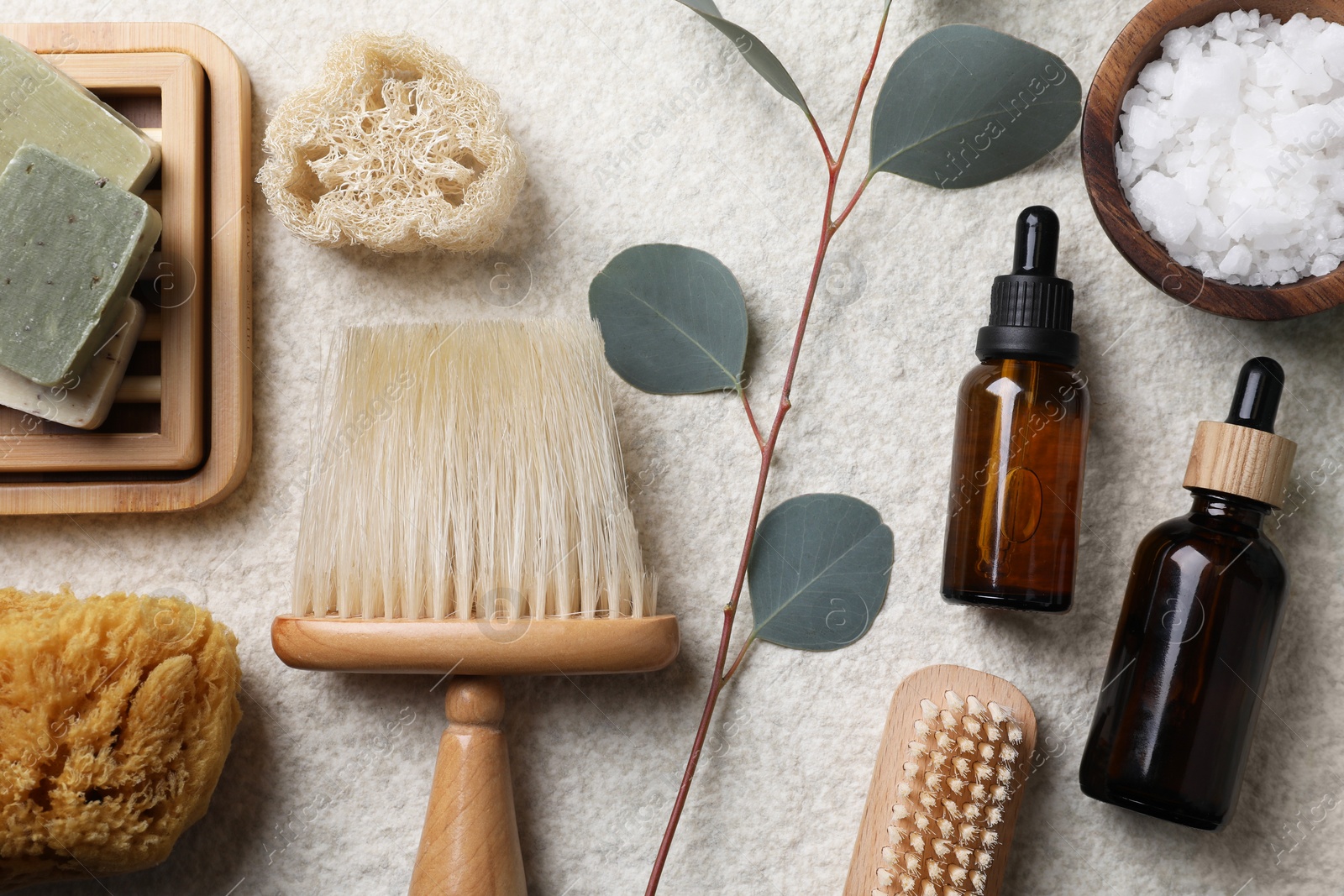 Photo of Flat lay composition with different spa products and eucalyptus branch on light grey textured table