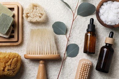 Photo of Flat lay composition with different spa products and eucalyptus branch on light grey textured table