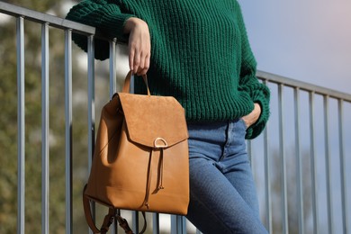 Young woman with stylish backpack on autumn day, closeup