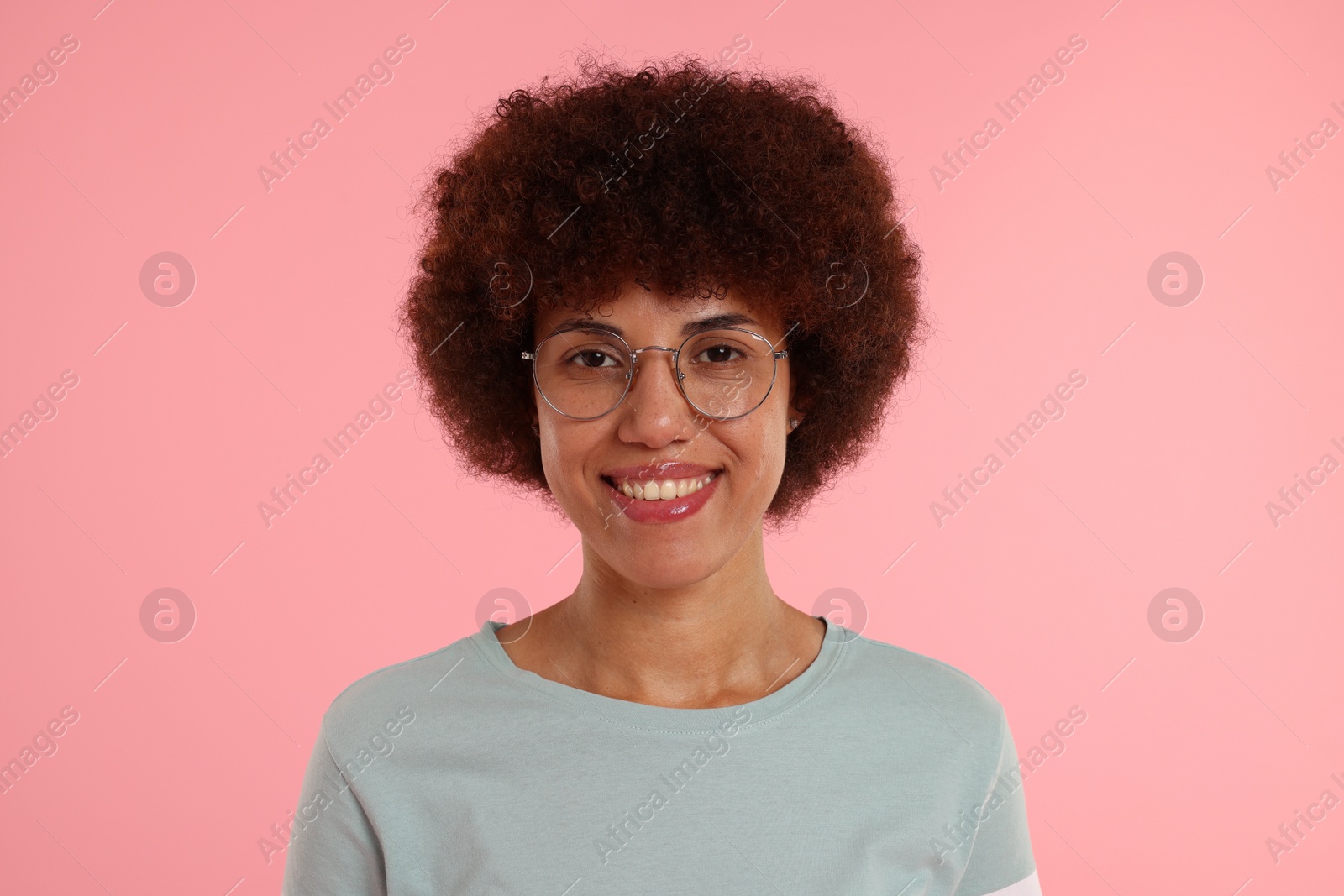 Photo of Portrait of happy young woman on pink background