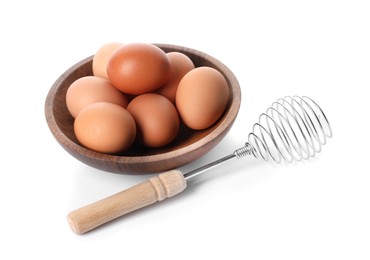 Photo of Whisk and bowl with raw eggs isolated on white