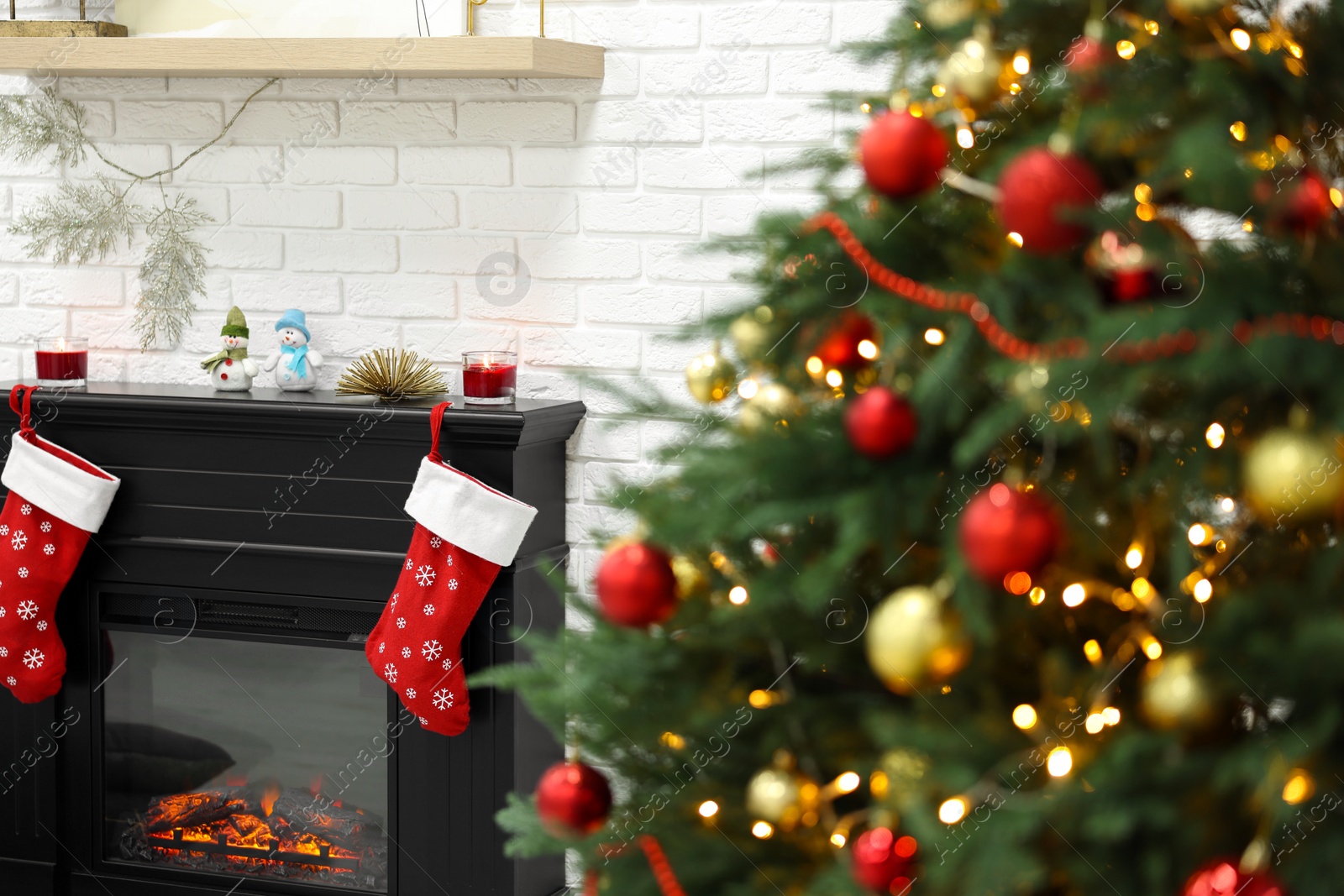 Photo of Beautiful Christmas tree near fireplace indoors. Interior design