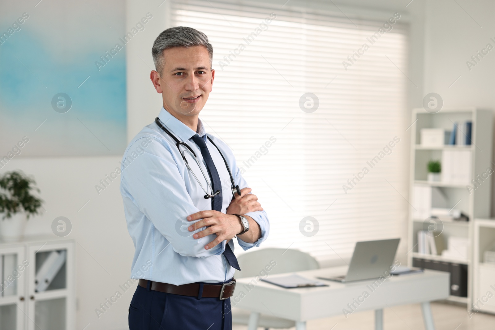 Photo of Portrait of doctor with stethoscope in clinic, space for text