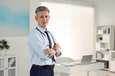 Portrait of doctor with stethoscope in clinic, space for text