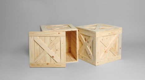 Photo of Pair of wooden crates on grey background