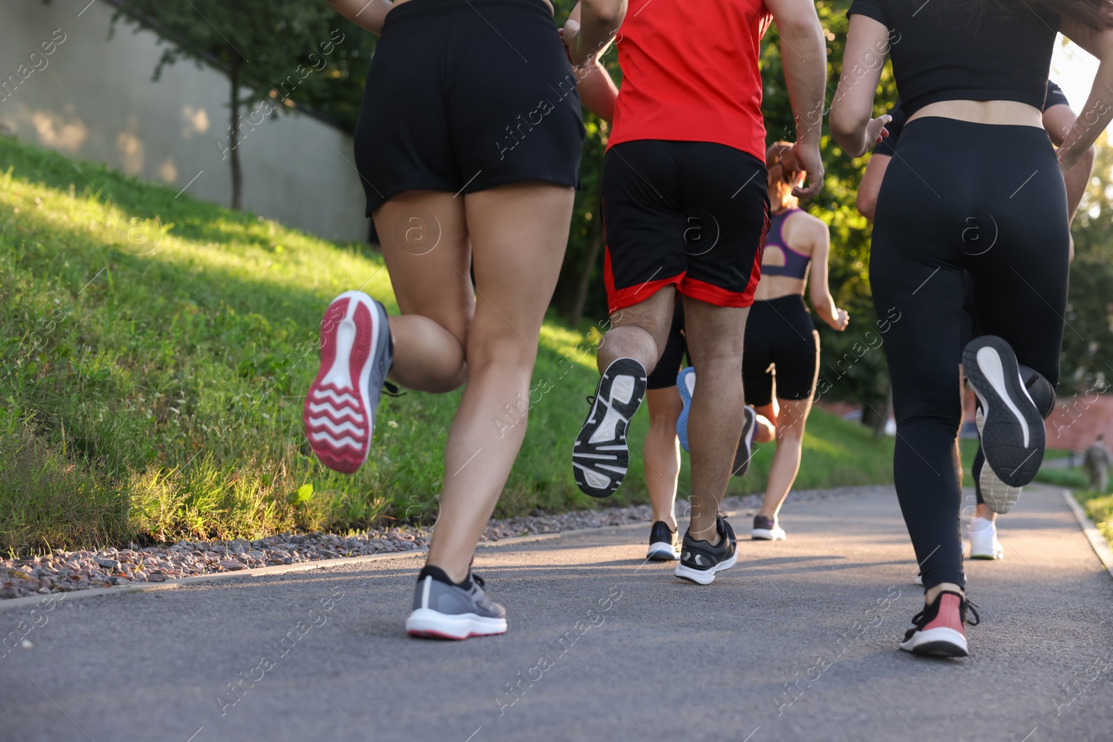 Photo of Group of people running outdoors, closeup view