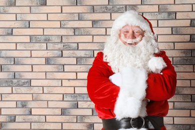 Photo of Authentic Santa Claus on brick wall background