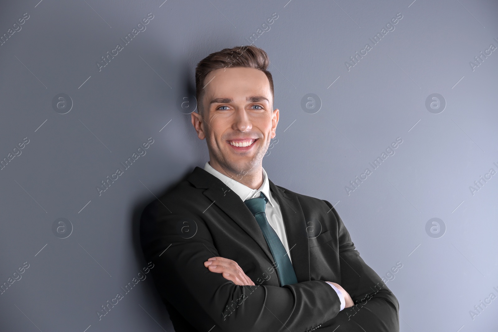 Photo of Portrait of young man with beautiful hair on grey background