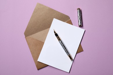 Photo of Blank sheet of paper, letter envelope and pen on violet background, top view