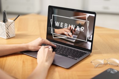 Webinar. Woman using laptop at table, closeup