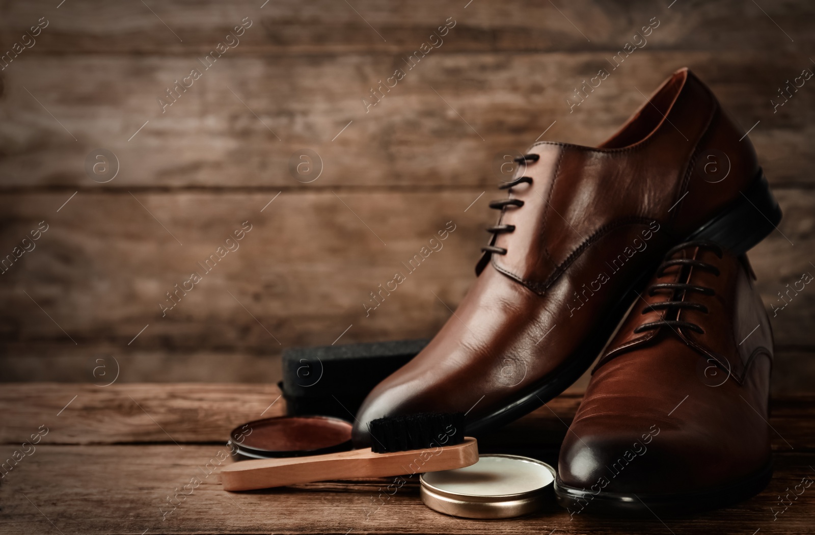 Image of Shoe care accessories and footwear on wooden background. Space for text