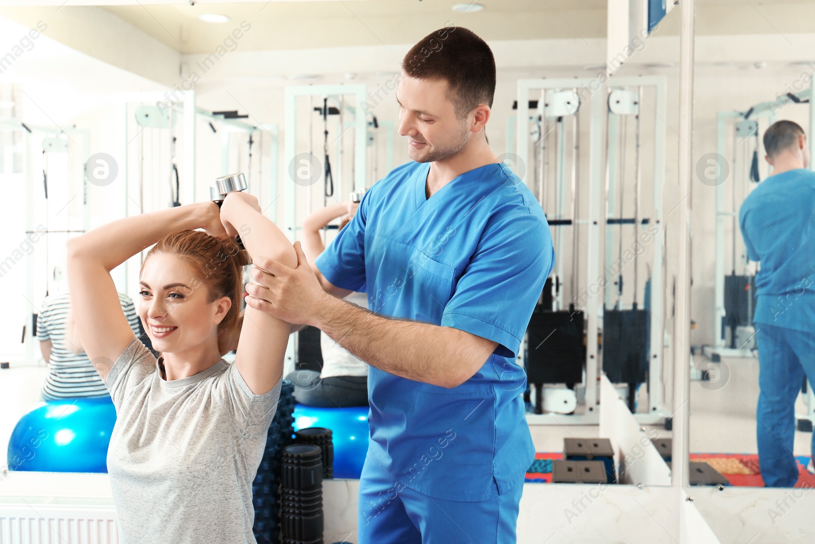 Photo of Patient exercising under physiotherapist supervision in rehabilitation center