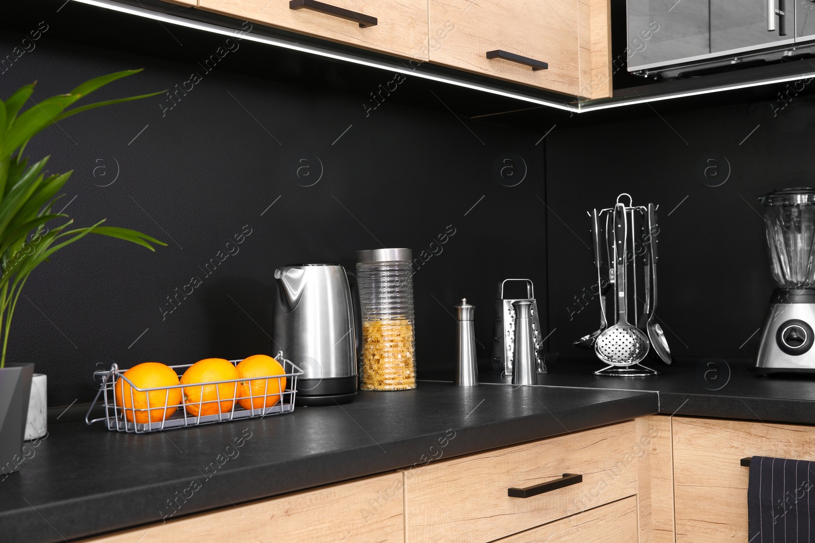 Photo of Stylish kitchen counter with houseware, appliances and products